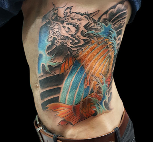 Oriental Koi Dragon transition becomming colour black grey ink color tattooed men